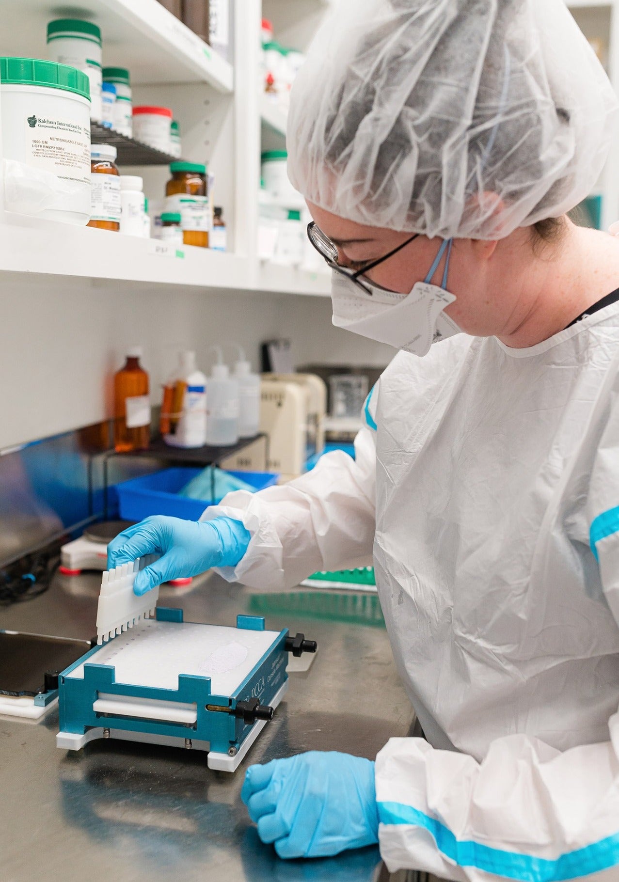 A Thornhill's Pharmacy compounding technician in protective gear preparing a patient-specific medication